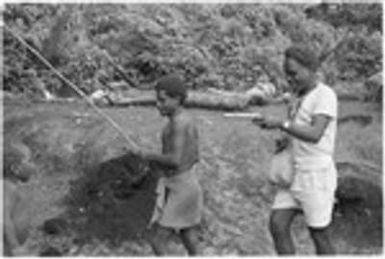 Laete'eboo and bamboo with shell money string on it, first of the mortuary feast; it will go in the ruu ritual bundle for mamu magic