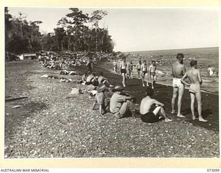 MALAHANG BEACH, NEW GUINEA. 1944-05-14. ALLIED AND AUSTRALIAN TROOPS ENJOYING A SWIM ON THEIR REST DAY IN THE SEA NEAR LAE