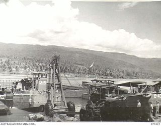 JACQUINOT BAY, NEW BRITAIN. 1944-12-01. BARGES BEING OVERHAULED AND REPAIRED AT THE MAINTENANCE SECTION BEACH-HEAD OF B COMPANY, 594TH ENGINEER BOAT AND SHORE REGIMENT, UNITED STATES ARMY NEAR THE ..