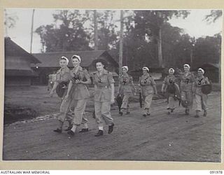 BOUGAINVILLE, 1945-04-19. AUSTRALIAN ARMY NURSING SERVICE (AANS) SISTERS, 2/1ST GENERAL HOSPITAL, LEAVE THE COMPOUND FOR DUTY AT 0730 HOURS (7.30 AM). IDENTIFIED ARE:- SISTER J.T. PURCELL (1); ..