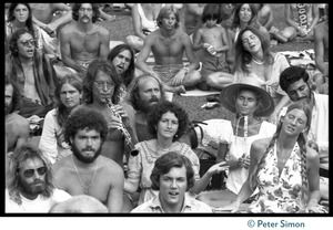 Audience members during Ram Dass's appearance at Andrews Amphitheater, University of Hawaii, one playing an oboe