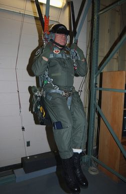 US Air Force (USAF) Major (MAJ) General (GEN) Mike DeCuir, Director of Air and Space Operations (ASO), Headquarters Air Combat Command (ACC), Langley Air Force Base (AFB), Virginia (VA), receives training on a parachute simulator at Barksdale Air Force Base's new B-52H Stratofortress egress trainer, in preparation for a flight to Andersen AFB, Guam (GU)