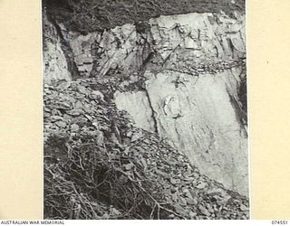 NEW GUINEA. 1944-07-09. A SECTION OF BADLY SLANTING ROCK STRATA ON THE NEW WAU-BULLDOG ROAD NEAR SECOMBE CAMP