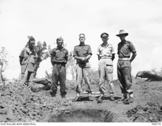 MOEM, WEWAK AREA, NEW GUINEA, 1945-09-17. THE REBURIAL SERVICE CONDUCTED BY CHAPLAIN S. COWEN, HQ 6 DIVISION (3), AT THE AIF WAR CEMETERY, FOR THREE AUSTRALIAN SOLDIERS OF THE Z SPECIAL FORCE WHOSE ..