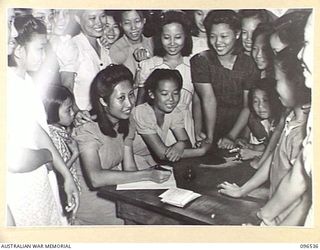 RABAUL AREA, NEW BRITAIN. 1945-09-13. CHINESE CIVILIANS, INTERNED BY THE JAPANESE AT A CAMP 15 MILES WEST OF RABAUL, WERE CONTACTED BY A PARTY OF AUSTRALIAN ARMY AND RED CROSS OFFICIALS SOON AFTER ..