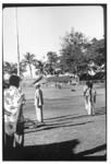 Men gathered beside flagpole