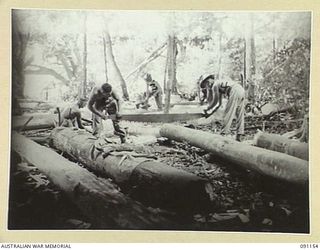 BANAK, AITAPE-WEWAK SECTOR, NEW GUINEA. 1945-04-21. MEMBERS OF 2/1 FIELD COMPANY, ROYAL AUSTRALIAN ENGINEERS, WORKING ON BRIDGE TIMBERS WHICH HAVE BEEN DROPPED TO A CENTRAL DUMP BY R4 TRACTORS FOR ..