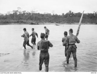 MIVO RIVER, BOUGAINVILLE, 1945-08-18. THE JAPANESE SURRENDER ENVOY SETTING OUT TO RE WADE THE MIVO RIVER ON THE SECOND STAGE OF THEIR RETURN JOURNEY TO LIEUTENANT-GENERAL M. KANDA, COMMANDER ..