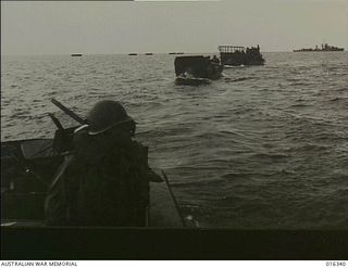 New Britain. 15 December 1943. A long line of landing barges approach the shores near Arawe while larger naval craft stand out to sea to shell enemy positions. The invasion was accomplished at ..