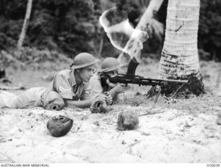 KIRIWINA, TROBRIAND ISLANDS, PAPUA. 1944-01-31. IN MODERN WARFARE, AERODROME DEFENCE IS VITAL AND THE RAAF HAS TRAINED A NUMBER OF "TOUGH GUYS" TO LOOK AFTER ITS POSSESSIONS. 1009 FLYING OFFICER A. ..