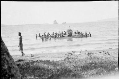 Canoes full of men and a Dukduk with the Beehives beyond, Rabaul Harbour, New Guinea, ca. 1929 / Sarah Chinnery