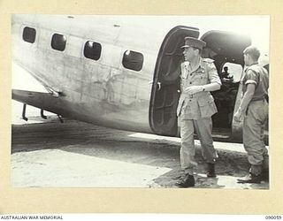 BOUGAINVILLE. 1945-03-30. LORD WAKEHURST, GOVERNOR OF NEW SOUTH WALES STEPS FROM THE PLANE AT PIVA AIRSTRIP ON HIS ARRIVAL AT TOROKINA, ON A VISIT WITH LADY WAKEHURST AND LADY BLAMEY, TO TROOPS IN ..