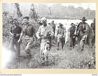 MIVO RIVER AREA, BOUGAINVILLE. 1945-08-18. FIRST CONTACT BETWEEN JAPANESE SURRENDER ENVOY AND AUSTRALIAN TROOPS ON BOUGAINVILLE. THE AUSTRALIAN RECEPTION PARTY DEPARTING FROM THE BANK OF THE MIVO ..