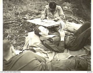 KILIGIA, NEW GUINEA. 1944-04-10. TROOPS AT HEADQUARTERS 5TH DIVISION AREA, AWAITING COMMENCEMENT OF THE FILM "CHARLEY'S AUNT". THEY ARE AT THE REAR OF THE SCREEN AS THE OPEN AIR CINEMA HAS FILLED. ..