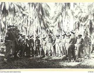 SIAR, NEW GUINEA. 1944-06-19. PERSONNEL OF NO.11 PLATOON, B COMPANY, 58/59TH INFANTRY BATTALION, LISTENING TO A LECTURE BY THE COMPANY SERGEANT MAJOR, VX89978 WARRANT OFFICER C.H. HOWE (12). ..