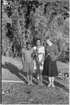 Large lizard, held by interpreter Kavali, flanked by Gana (l) and Ann Rappaport (r)