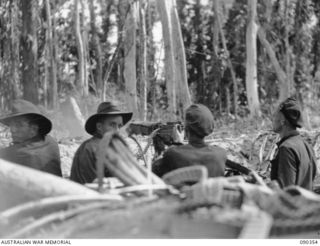 BOUGAINVILLE. 1945-04-05. A 25 INFANTRY BATTALION MEDIUM MACHINE-GUN CREW FIRING FROM SLATER'S KNOLL DURING ATTACK AGAINST THE JAPANESE WHO HAD DUG IN, IN A GULLY AFTER THEIR UNSUCCESSFUL COUNTER ..