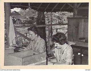 LAE, NEW GUINEA, 1945-05-16. PRIVATE A. KLYE (1), AND PRIVATE L. DAVIS (2), AUSTRALIAN WOMEN'S ARMY SERVICE PERSONNEL WORKING WITH THE ASSISTANT DIRECTOR OF MEDICAL SERVICES, HEADQUARTERS LAE BASE ..
