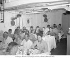 Bikini Resurvey members at dinner in the wardroom aboard the USS CHILTON, summer 1947