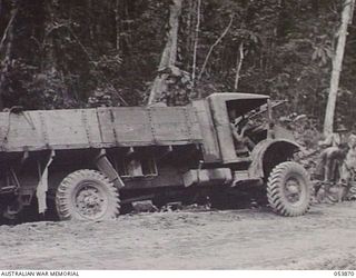 REINHOLD HIGHWAY, NEW GUINEA. 1943-07-06. TRUCK OF HEADQUARTERS, ROYAL AUSTRALIAN ENGINEERS, 11TH AUSTRALIAN DIVISION BOGGED ON THE HIGHWAY