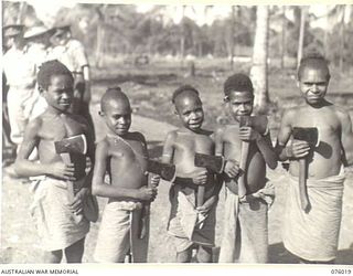 LAE, NEW GUINEA. 1944-09-18. THE FIVE NATIVE BOYS WHO ESCORTED BRIGADIER J. FIELD AND MAJOR J. SUMMERTON BACK TO TSILI TSILI AFTER THEIR AIRCRAFT HAD CRASHED IN THE JUNGLE WHILE ON THEIR WAY FROM ..