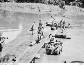 MEVELO RIVER, HENRY REID BAY, NEW BRITAIN. 5 MARCH 1945. PERSONNEL OF THE 4TH FIELD COMPANY, BUILDING A BRIDGE OVER THE RIVER NEAR THE BERA RIVERS JUNCTION, TROOPS OF C COMPANY, 14/32ND INFANTRY ..