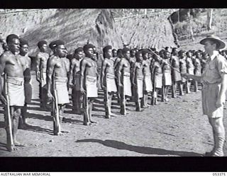 BISIATABU, SOGERI VALLEY, NEW GUINEA. 1943-07-01. "C" COMPANY, 1ST PAPUAN INFANTRY BATTALION ON PARADE. IN CHARGE OF THE PARADE IS Q186189 WARRANT OFFICER 2 T. A. BRUCE, "C" COMPANY SERGEANT MAJOR