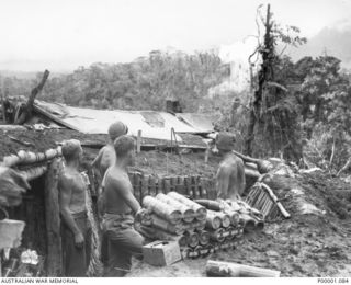 THE SOLOMON ISLANDS, 1945-03-27. AUSTRALIAN MORTAR CREW WATCHING THE RESULT OF THEIR SHOOTING NEAR THE NUMA NUMA TRAIL ON BOUGAINVILLE ISLAND. (RNZAF OFFICIAL PHOTOGRAPH.) (SAME PHOTOGRAPH AS ..