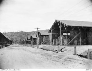 RABAUL, NEW BRITAIN, 1946-04-03. ONE OF THE MANY LINES OF STORE BUILDINGS AT 2 BASE SUPPLY DEPOT. THESE BUILDINGS MEASURE 100 FEET BY 45 FEET. NOTE THE THOROUGHFARES AND DRAINAGE SYSTEM, INDICATING ..