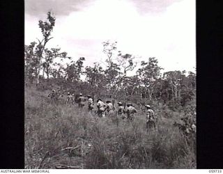 SOGERI, NEW GUINEA. 1943-11-04. NCOS UNDERGOING THE JUNIOR LEADERS COURSE AT THE NEW GUINEA FORCE TRAINING SCHOOL SETTING OUT OVER THE HILLS DURING ONE OF THEIR TRAINING PERIODS