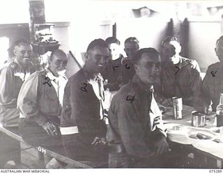 MADANG, NEW GUINEA. 1944-08-15. OFFICERS OF THE 165TH GENERAL TRANSPORT COMPANY ENJOYING THEIR DINNER IN THE UNIT OFFICER'S MESS. IDENTIFIED PERSONNEL ARE:- NX59650 LIEUTENANT R.F. O'NEIL (1); ..