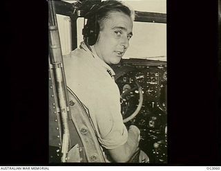 The pilot (unidentified) in the cockpit of the Lockheed Lodestar aircraft of No. 37 Squadron RAAF which escorted the Supermarine Spitfire aircraft of No. 452 Squadron RAAF during the move of the ..