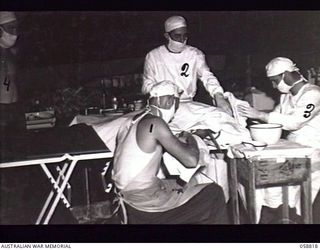 DUMPU, NEW GUINEA. 1943-10-15. AN OPERATION IN PROGRESS IN THE OPERATING THEATRE AT THE 2/6TH AUSTRALIAN FIELD AMBULANCE WITH "E" SURGICAL TEAM. SHOWN ARE:- NX26567 SERGEANT W. G. SMITH (2); ..