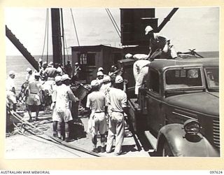 OCEAN ISLAND. 1945-10-02. FOLLOWING THE SURRENDER OF THE JAPANESE TROOPS OF 31/51 INFANTRY BATTALION OCCUPIED THE ISLAND. SHOWN, A JAPANESE WORKING PARTY LOADING SUPPLIES FROM THE SS RIVER BURDEKIN ..