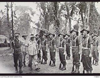 TOROKINA, BOUGAINVILLE. 1945-10-29. GENERAL SIR THOMAS A. BLAMEY, COMMANDER IN CHIEF, AUSTRALIAN MILITARY FORCES, ACCOMPANIED BY LIEUTENANT G. R. H. GLANVILLE, INSPECTING MEMBERS OF 2/1ST GUARD ..