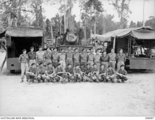 Group portrait of personnel of Headquarters 2/4th Armoured Regiment Workshops. Left to right, back row: NX72523 Corporal (Cpl) E Wardle of Thirroul, NSW; NX127950 Craftsman (Cfn) E G Wilson of ..