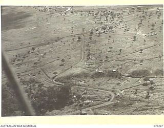 DUMPU, RAMU VALLEY, NEW GUINEA, 1944-02-10. AN AERIAL VIEW TAKEN FROM A HEIGHT OF 300 FEET OF THE GENERAL AREA AT 7TH DIVISION SIGNAL HEADQUARTERS, LOOKING TOWARDS THE NORTH EAST. URIA RIVER LIES ..