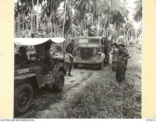 MADANG, NEW GUINEA. 1944-04-26. AUSTRALIAN TROOPS EXAMINE AN ABANDONED JAPANESE TRUCK WHICH HAS BEEN CHALKED WITH ALLIED DESCRIPTIONS. THE VEHICLE IS ONE OF MANY ABANDONED JAPANESE TRUCKS BEING ..