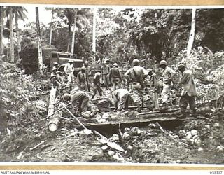 LANGEMAK AREA, NEW GUINEA, 1943-11-01. TROOPS OF THE 870TH UNITED STATES ENGINEER AVIATION BATTALION BUILDING A BRIDGE ON THE ROAD TO THE NEW AERODROME IN THE DREGER HARBOUR AREA. ENGINEERS REBUILD ..