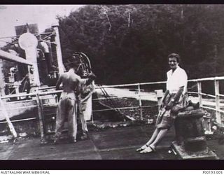 SALAMAUA, NEW GUINEA, C. 1945. MEMBERS OF THE AUSTRALIAN WOMEN'S ARMY SERVICE (AWAS) WITH AN AUSTRALIAN SOLDIER ON THE WRECK OF THE JAPANESE TRANSPORT KOTOKU MARU, WHICH WAS ABANDONED AFTER BEING ..