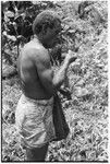 Larikeni talks to his ancestors with a betel nut, areca, and then eats it