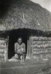 An old leper in front of his hut