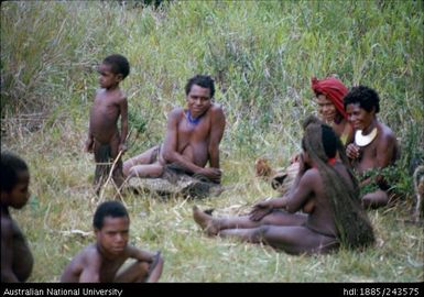 Women and children in the grass