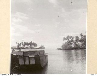 LANGEMAK BAY, FINSCHHAFEN AREA, NEW GUINEA. 1944-07-02. THE JETTY FROM WHICH A LANDING BARGE TRANSPORTS TROOPS TO AN AMERICAN 300 TON ARMOURED LANDING CRAFT MOORED OFF SHORE