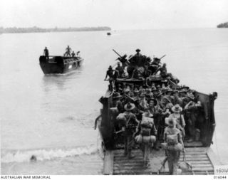 Finschhafen Area, New Guinea. October 1943. An Australian infantry battalion embark for the forward line at Scarlet Beach