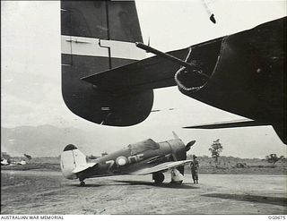 NADZAB, NEW GUINEA. C. 1944-02. A BOOMERANG FIGHTER AIRCRAFT, SERIAL NO. 7-OE, OF NO. 4 (ARMY COOPERATION) SQUADRON RAAF ON THE AIRFIELD AFTER LANDING FOLLOWING A STRAFING RAID ON JAPANESE ..