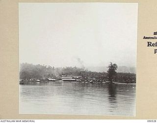 JACQUINOT BAY, NEW BRITAIN. 1945-04-12. THE AUSTRALIAN DETAIL ISSUING DEPOT ON THE FAR BANK OF A SMALL BAY ADJOINING THE AUSTRALIAN BARGE UNIT HQ. BARGES LOAD UP HERE WITH SUPPLIES FOR WIDE BAY