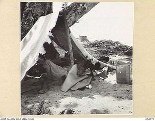 BRANDI, NEW GUINEA. 1945-09-07. A JAPANESE PRISONER ASLEEP IN HIS OWN LITTLE TENT NEAR THE 35 INFANTRY BATTALION CAMP AREA