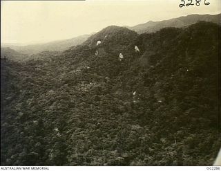 NORTH EAST NEW GUINEA. 1945-03-09. NOT ONLY DO AIRMEN AND GROUND FORCES HAVE TO CONTEND WITH THIS TYPE OF RUGGED JUNGLE COUNTRY BUT THEY ALSO HAVE TO FACE SHEER ROCK-FACED CLIFFS LIKE THOSE SHOWN ..