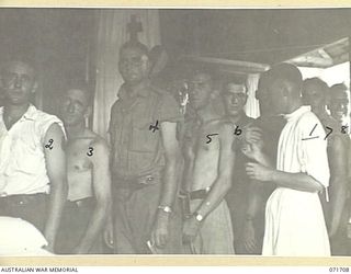 LAE, NEW GUINEA, 1944-03-25. SX19771 PRIVATE (PTE) R. J. COULTAS (1), A MEMBER OF THE 2/7TH GENERAL HOSPITAL, SWABS IODINE ON PATIENTS WAITING FOR T.A.B. (MIXED VACINE, TYPHOID AND PARATYPHOID A ..